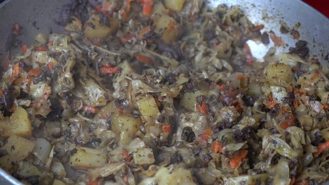Close up of Arrimado de Col cooking and smooking, homemade typical Peruvian food
