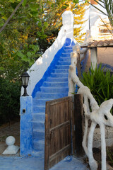 Blue and white stairs with entrance door, modernist and gothic style