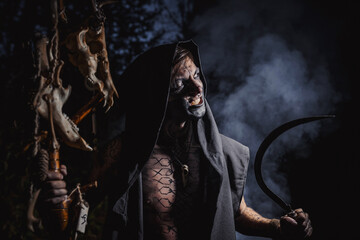Sorcerer with marks on his body in the forest