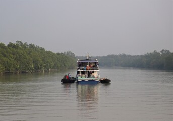 Tourist launches on the river beside the largest mangrove forest Sundarbans in Bangladesh 