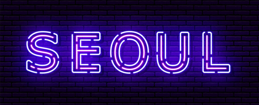 Glowing neon sign with the inscription of the Korean city of Seoul. In blue and purple colors. Against a brick wall.