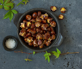 Roasted chestnuts on an old board. Selective focus.