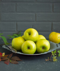 Green apples in a gray cup. Selective focus.