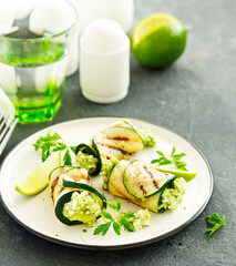 Zucchini rolls stuffed with cottage cheese and avocado. Snack. Selective focus.
