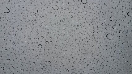 a drop of water seen through a window.