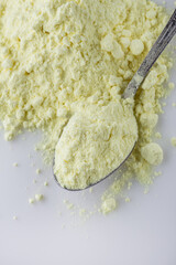 purified sulfur powder on a white acrylic background