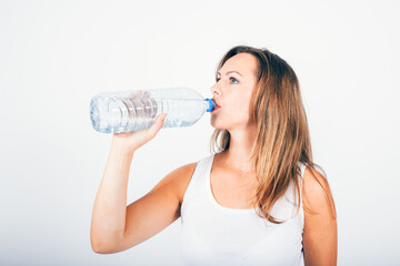 blond woman drinking water from  bottle