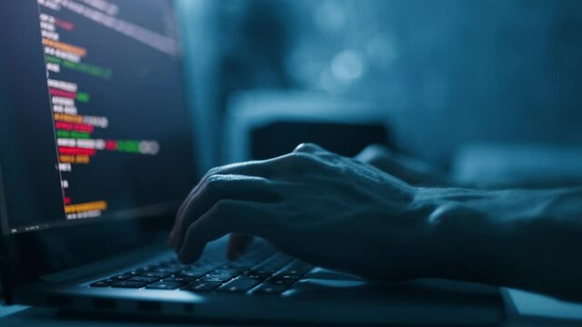 Close up hand of developing programming and coding technologies. Programmer hand typing on keyboard. Put on the wood table at night. Programmer concepts.