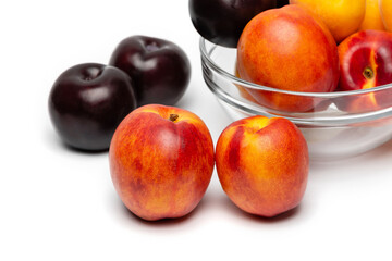 nectarine, peach and plum on a white background