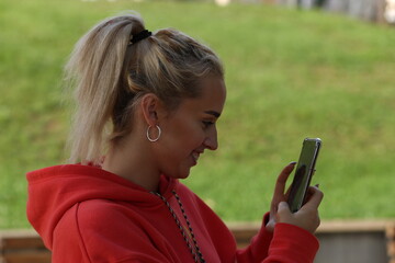 Young blonde woman with mobile phone