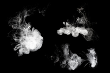 Set of abstract isolated moving smoke on black background. White luminous isolated chaotic puffs of smoke. Smoke collection