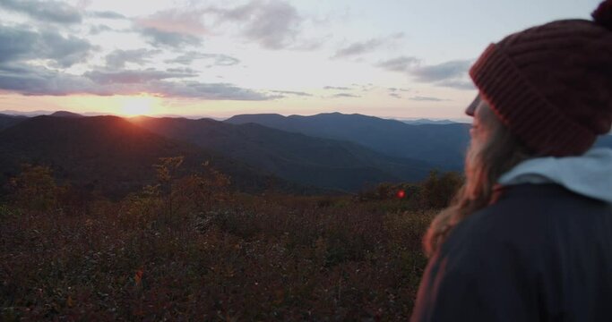Beautiful young hiker woman watching the sunset over Appalachian Mountains