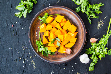 Beautifully chopped pumpkin salad, herbs, and ingredients for the dish. Creative atmospheric decoration