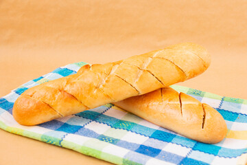 two French fresh, crispy garlic baguette for breakfast on a towel