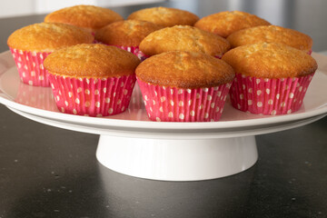 Home baked cupcakes in dark background, pink with dots