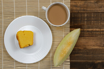 Brazilian breakfast with coffee with milk, corn cake and watermelon