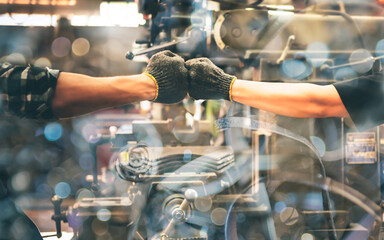 Experienced entrepreneurs, 2 engineers man Used hand for fist bump to show their cooperation For success teamwork, with blur soft of industrial machinery background, to people and synergy concept.