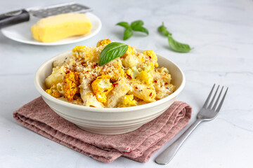 Cauliflower Pasta with Breadcrumbs and Chili Flakes Garnished with Fresh Basil Leaves 