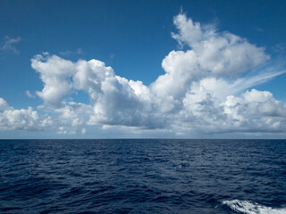 Blue sky with white clouds/ natural landscapes over the blue sea. 