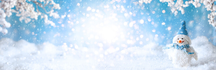 Funny Snowman on winter snowy background with snowy branches. Christmas or Winter concept.