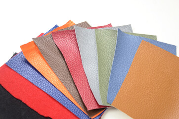 The colored leather sample. Samples of different colored genuine leather isolated on a white...