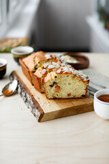 Pie with apricot jam on a wooden board on a light table. View from above.