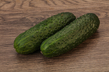Green fresh cucumbers over background