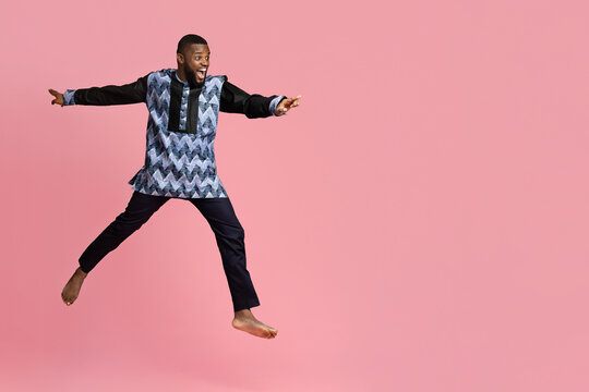 Excited black man running towards copy space for advertisement