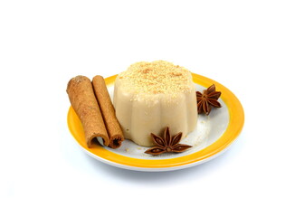 Hazelnut caramel pudding sprinkled with ground biscuits isolated on white background.