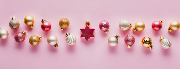 A lot of Christmas balls of pink and gold color.