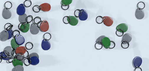 Lots of plastic magnetic intercom keys on a white table. Variety of colors. 3d render