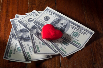 Red heart on a pile of money.