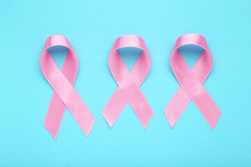 Cancer concept. Pink ribbons on blue background