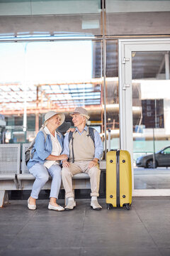 Happy senior tourist couple sitting on the bench