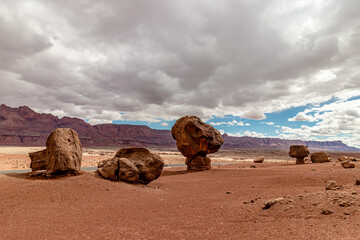 Fototapeta na wymiar Mega size boulders next to the highway, picnic bench for scale, Vermillion cliff range, Page, AZ, USA