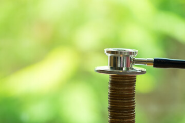 Obraz premium Money, Financial and Business Concept. Close up of stethoscope on top of stack of coins with copy space.