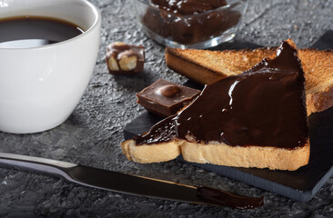 Toast with coffee and chocolate cream cheese. Breakfast with toast. Chocolate-covered toast.