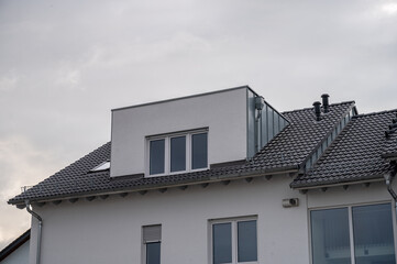 Fototapeta na wymiar modern semi-detached house with flat roof dormer with aluminum cladding