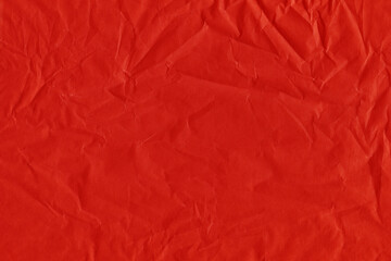 Fototapeta premium Red vintage and old looking crumpled paper background. Retro cardboard texture. Grunge paper for drawing. Ancient book page. Present wrapping.