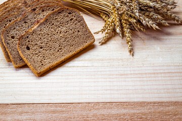 Traditional bread. Fresh loaf of rustic traditional bread with wheat grain ear or spike plant on...