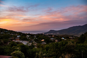 night panoramic view of the mountain village and blue sky with stars