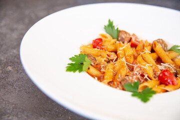 pasta with herbs in a white plate