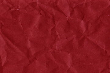 Red vintage and old looking crumpled paper background. Retro cardboard texture. Grunge paper for drawing. Ancient book page. Present wrapping.