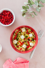 Bulgur with cheese, pepper, eggplant and pomegranate. Healthy eating. Vegetarian food. Diet.