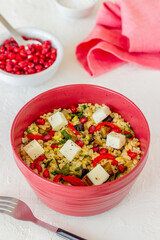 Bulgur with cheese, pepper, eggplant and pomegranate. Healthy eating. Vegetarian food. Diet.