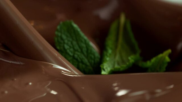 Super slow motion of pouring dark hot chocolate with mint leaves. Filmed with cinema high speed camera, 1000fps.