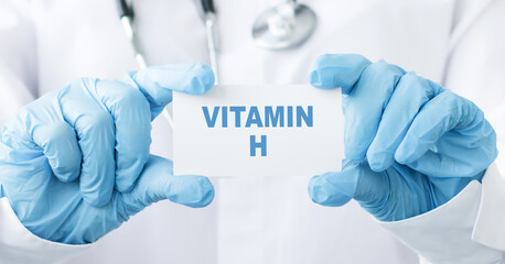 Close-up of female doctor holding a tablet with the text Vitamin H. Medical concept.