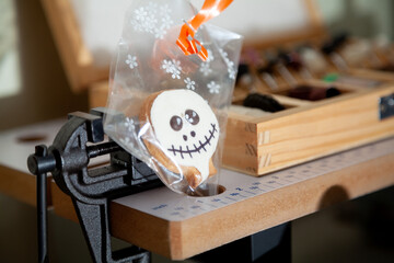 Round cookie mask for Halloween stands next to vise