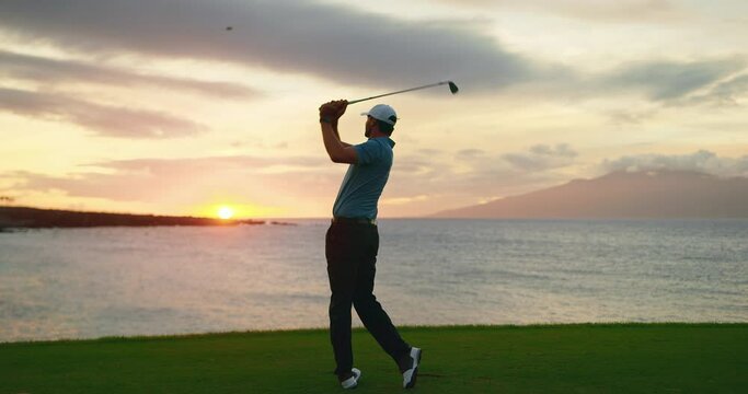 Sunset golf, man swinging and hitting golf ball at sunset