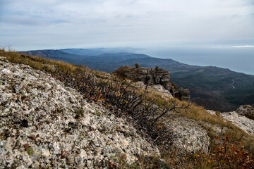 panoramic view of yellow autumn mountains against a background of blue haze and storm clouds filmed from a drone